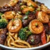 Fried noodles with garlic butter, steak and shrimp